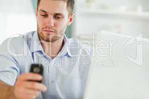 Businessman with laptop and mobile phone