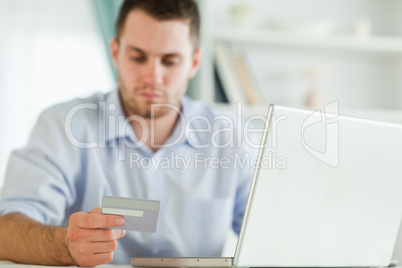 Businessman with credit card and notebook