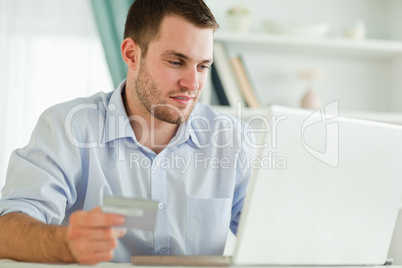 Businessman with laptop and credit card