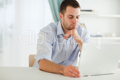 Businessman reading an e-mail on his laptop