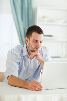 Sleepy businessman sitting at his laptop