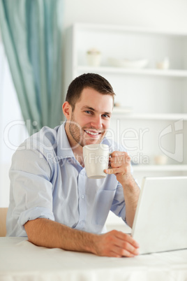 Smiling businessman having a cup of coffee