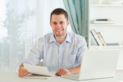 Smiling businessman holding a letter