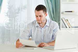 Businessman reading a letter in his homeoffice