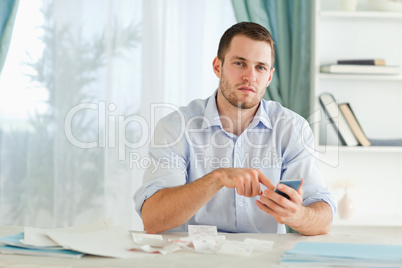 Businessman using his electronic calculator