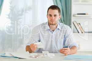 Businessman with calculator checking invoices