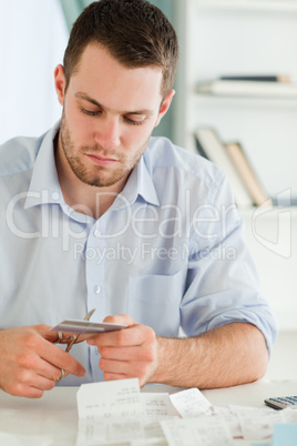 Businessman cutting his credit card