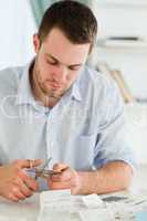 Businessman cutting his credit card into pieces