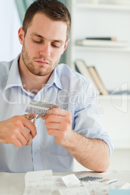 Businessman using scissor to destroy his credit card