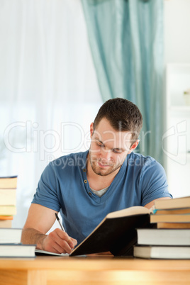 Male student preparing book report