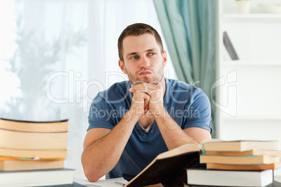 Student sitting at his desk in thoughts