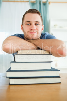 Student leaning on his books