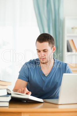 Student using his notebook for his homework