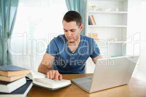 Student uses his laptop to work through his subject material