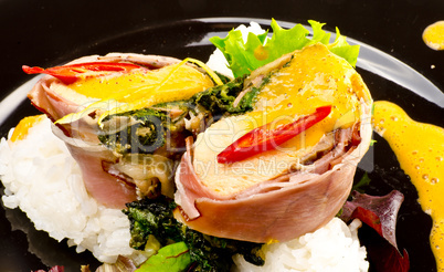 Salmon in ham covers and spinach