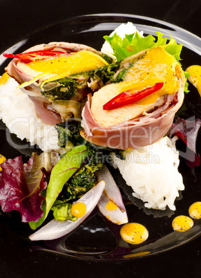 Salmon in ham covers and spinach