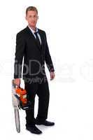 Selfconfident businessman with chainsaw