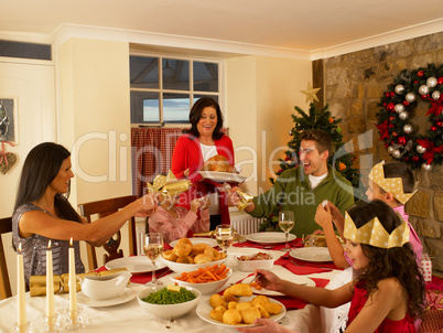 Hispanic family having Christmas dinner