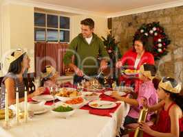 Hispanic family serving Christmas dinner