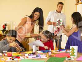 Hispanic family making Christmas cards