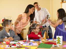 Hispanic family making Christmas cards