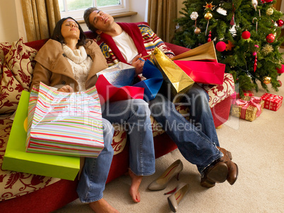 Young Hispanic couple resting after Christmas shopping