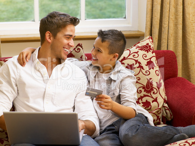 Hispanic father and son shopping online