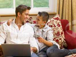 Hispanic father and son shopping online