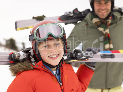 Pre-teen Boy With Father On Ski Vacation