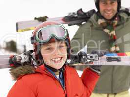 Pre-teen Boy With Father On Ski Vacation