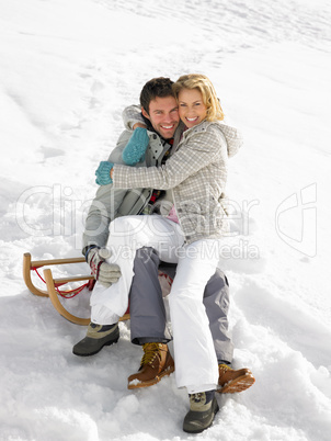 Young Couple On A Sled