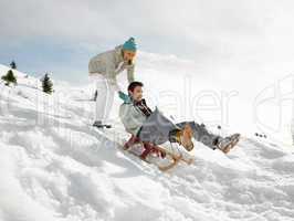 Young Couple Sledding