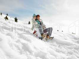 Young Couple Sledding