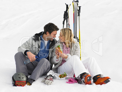Young Couple With Picnic On Ski Vacation