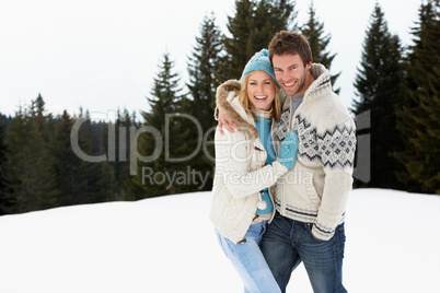 Young Couple In Alpine Snow Scene