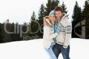 Young Couple In Alpine Snow Scene