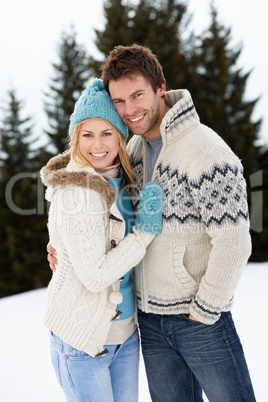 Young Couple In Alpine Snow Scene