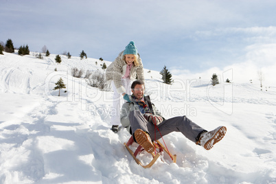 Young Couple Sledding