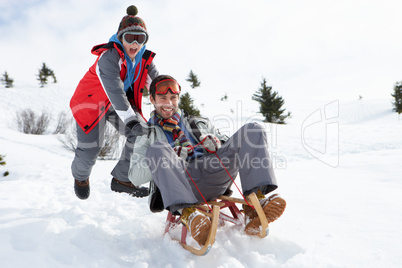 Young Father And Son Sledding