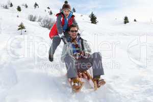 Young Father And Son Sledding