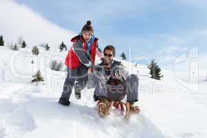 Young Father And Son Sledding