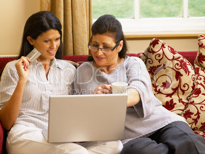 Hispanic mother and daughter shopping online