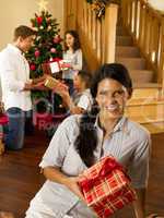 Hispanic family exchanging gifts at Christmas