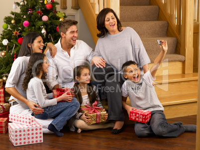 Hispanic family taking photos at Christmas