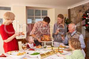 Family serving Christmas dinner