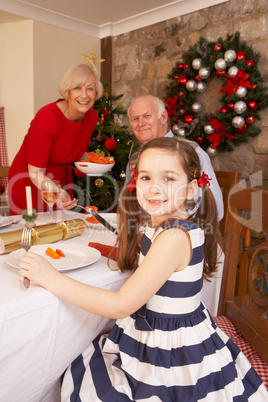 Child having Christmas dinner with grandparents