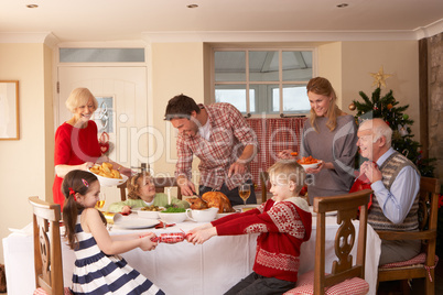 Family serving Christmas dinner
