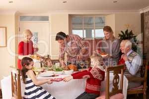 Family serving Christmas dinner