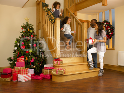 Young mixed race family on Christmas morning