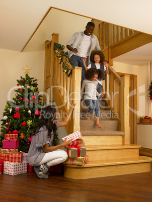 Young African American family on Christmas morning